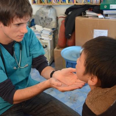 A teenagers gains medical work experience working with a boy in Mongolia A Projects Abroad intern meets with a patient on our medical internship for teenagers in Mongolia